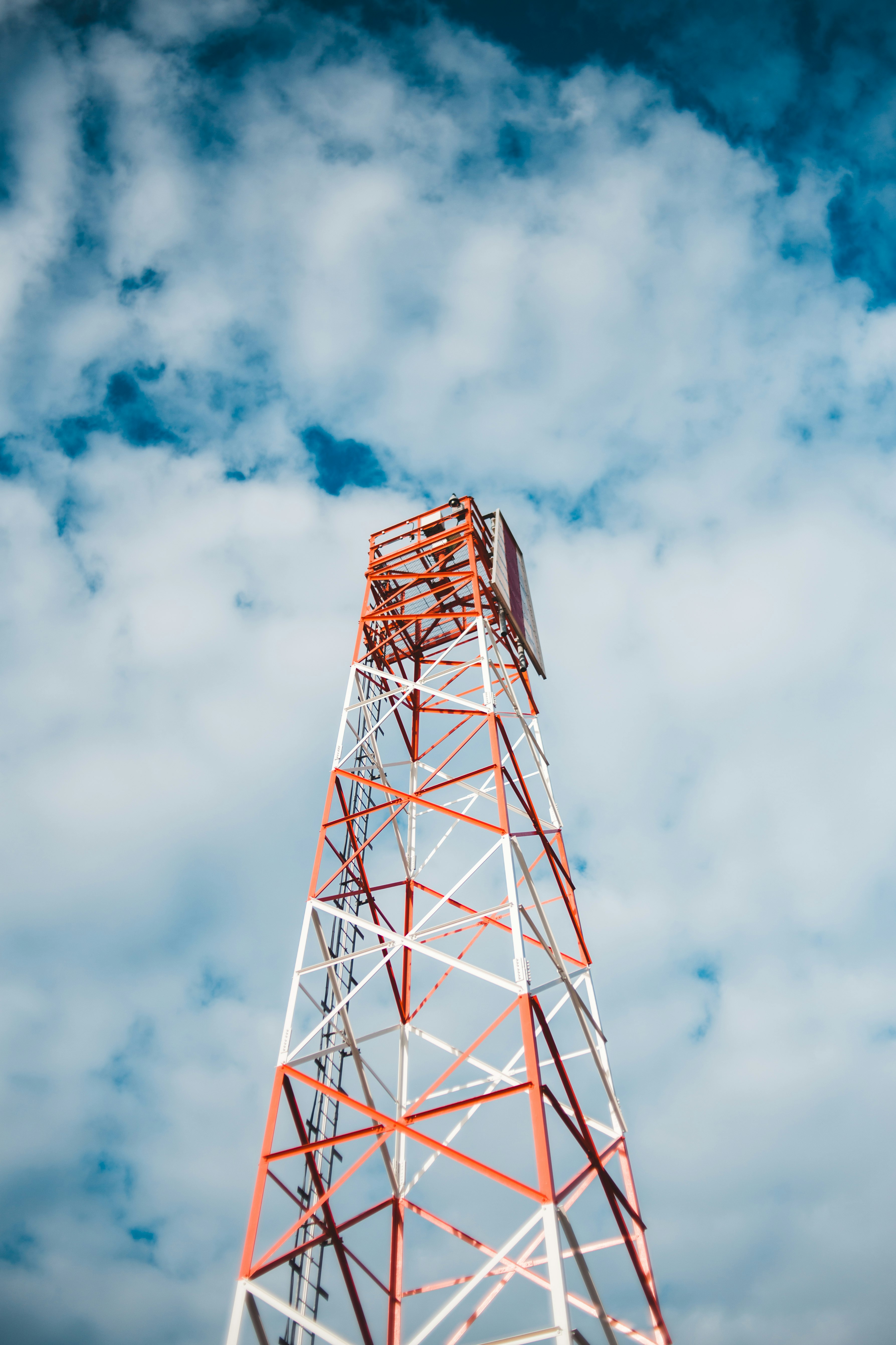 red and white tower under cloudy sky